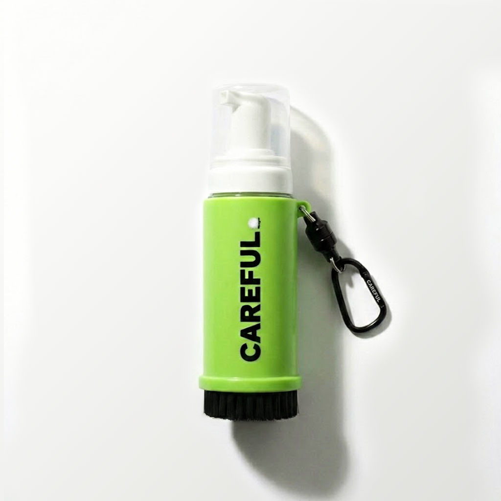 Green and white spray bottle with 'CAREFUL' text on a white background