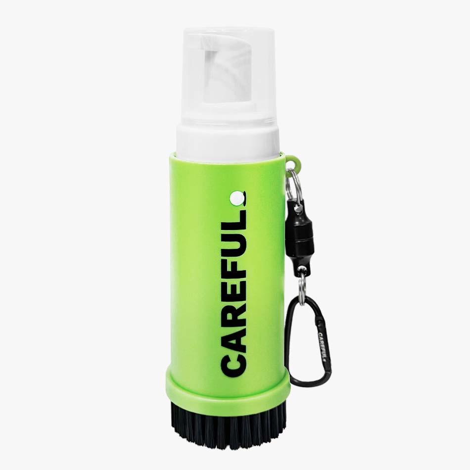 Careful Golf Golf Care Kit product contents showing the 4 oz 4-in-1 Premium Foaming Golf Cleaner inserted inside Careful Caddy brush with Magnetic Key Chain for portability and use on cleaning Golf Clubs, Grips, Balls and Shoes